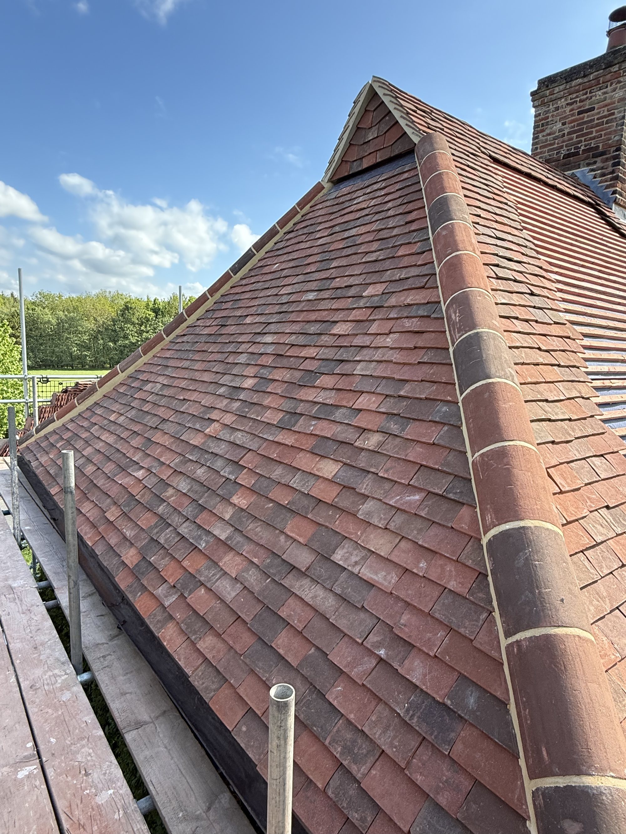 Newly completed tiled roof with decorative ridge and hip tiles