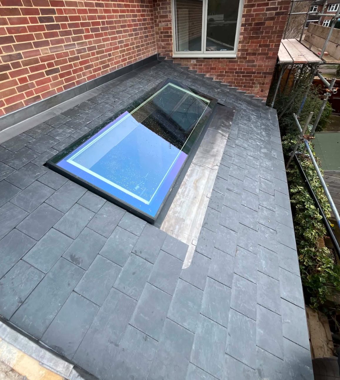 Completed slate roof with a large rooflight